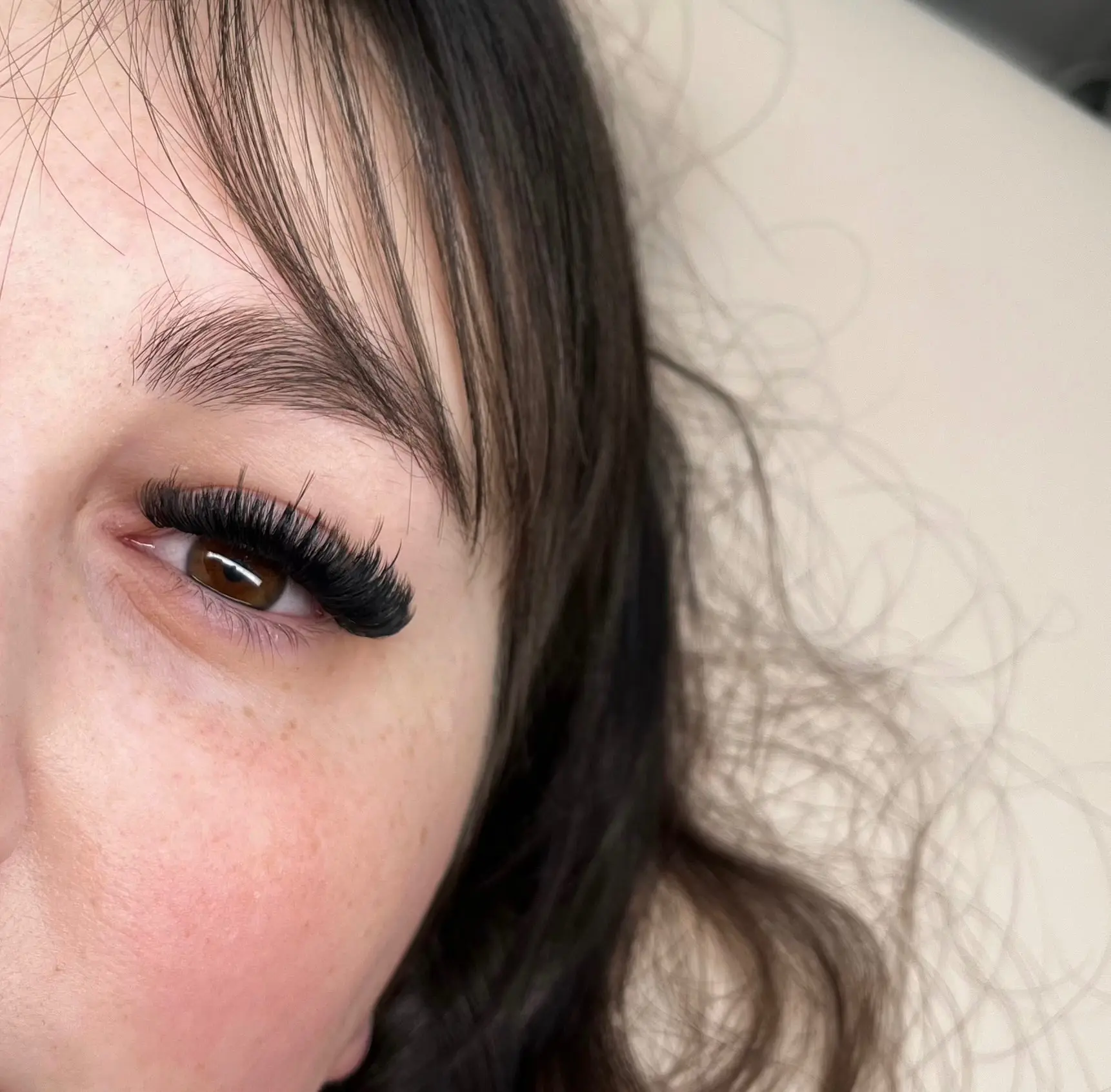 Dark volume lashes on a client with a fringe