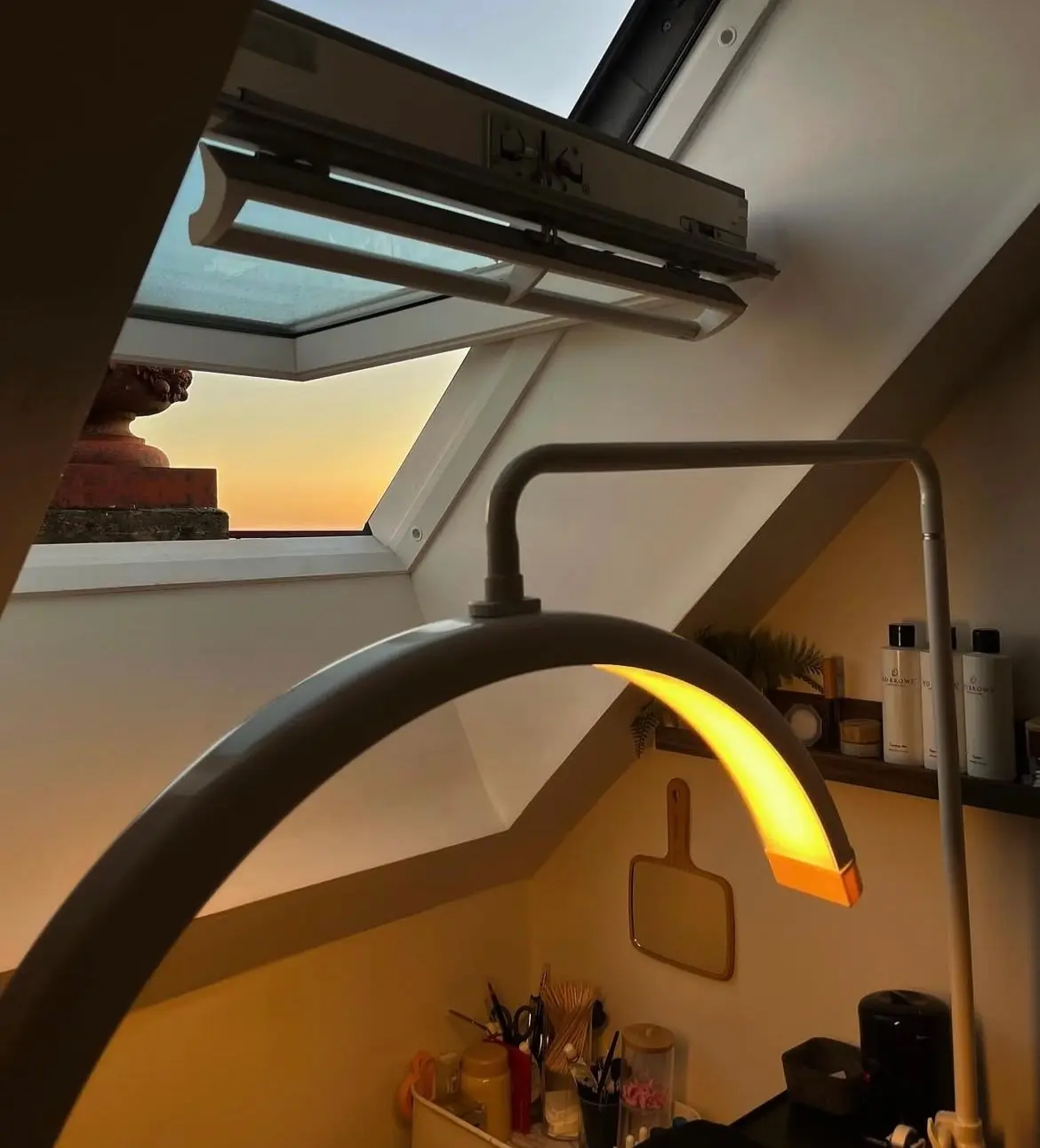 The lamp glowing under the skylight at sunset